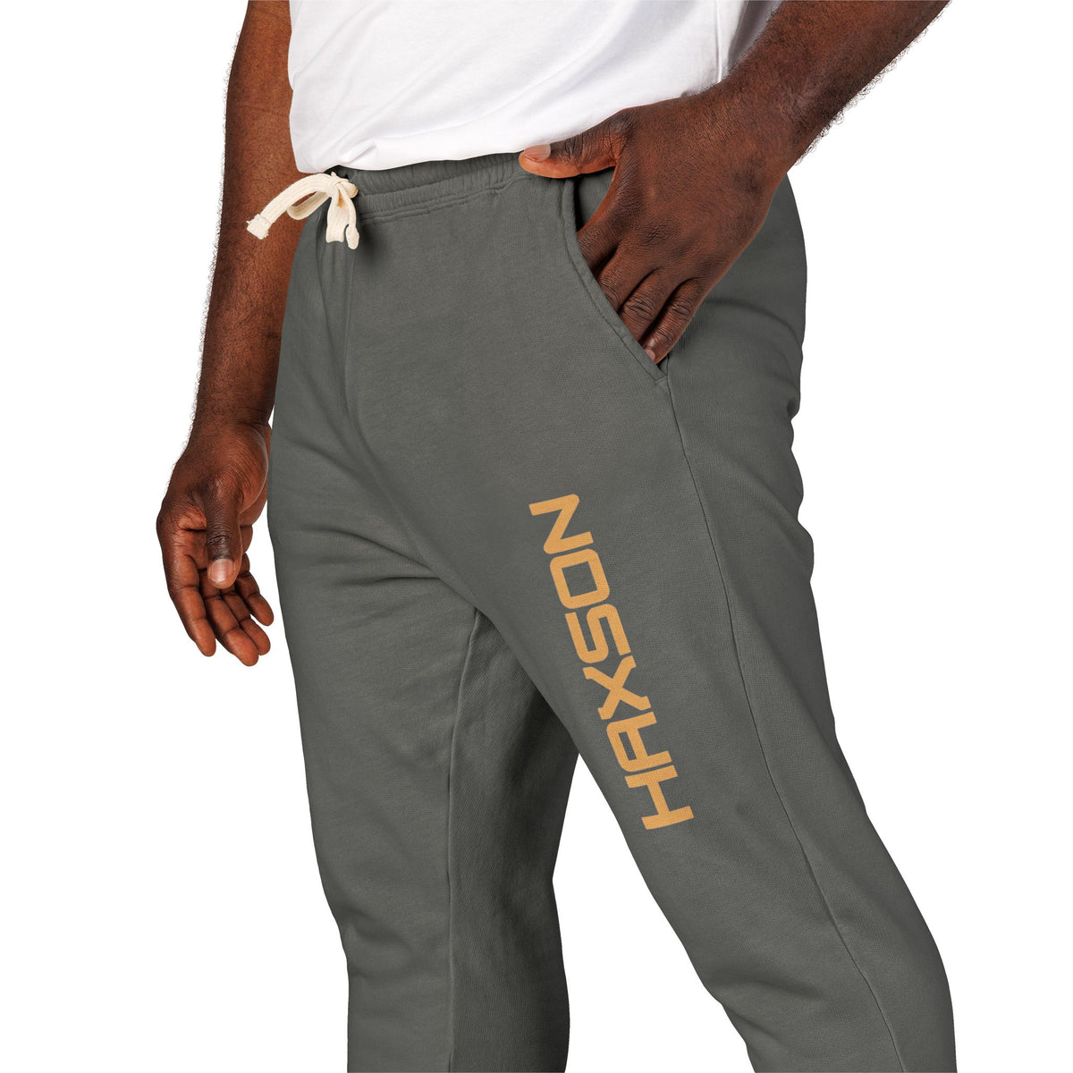 Gray sweatpants with 'dope shop' logo worn by a person on a white background